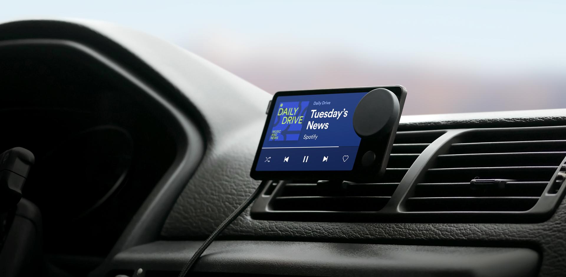 car thing attached to car vent playing a podcast