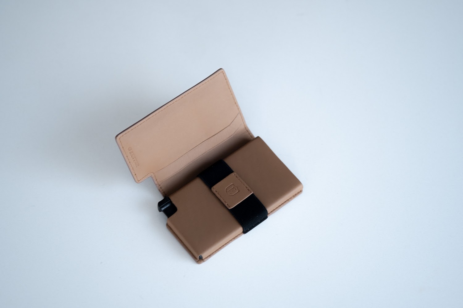 Ekster Wallet opened, showing elastic band inside
