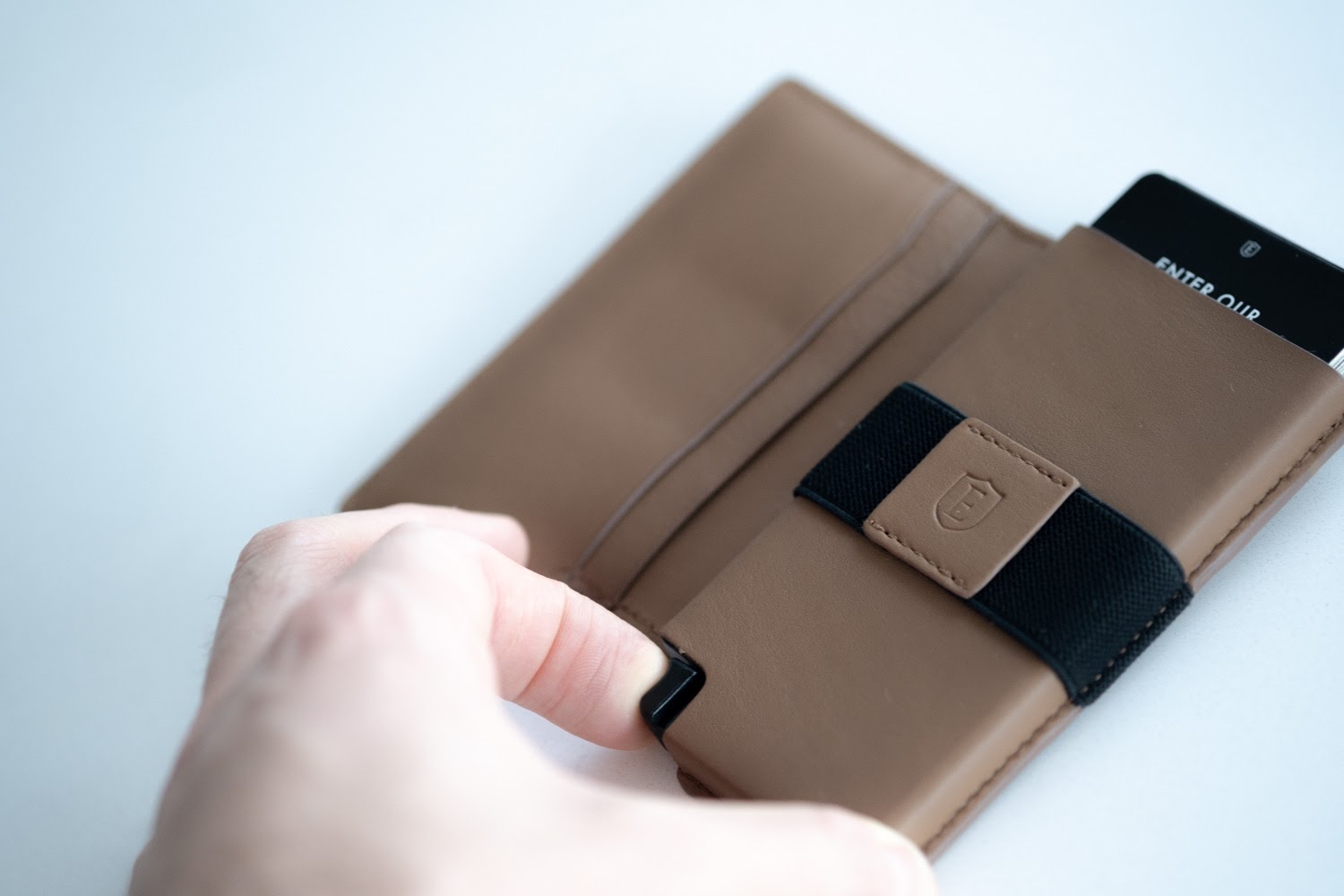 man using release mechanism for ekster wallet review