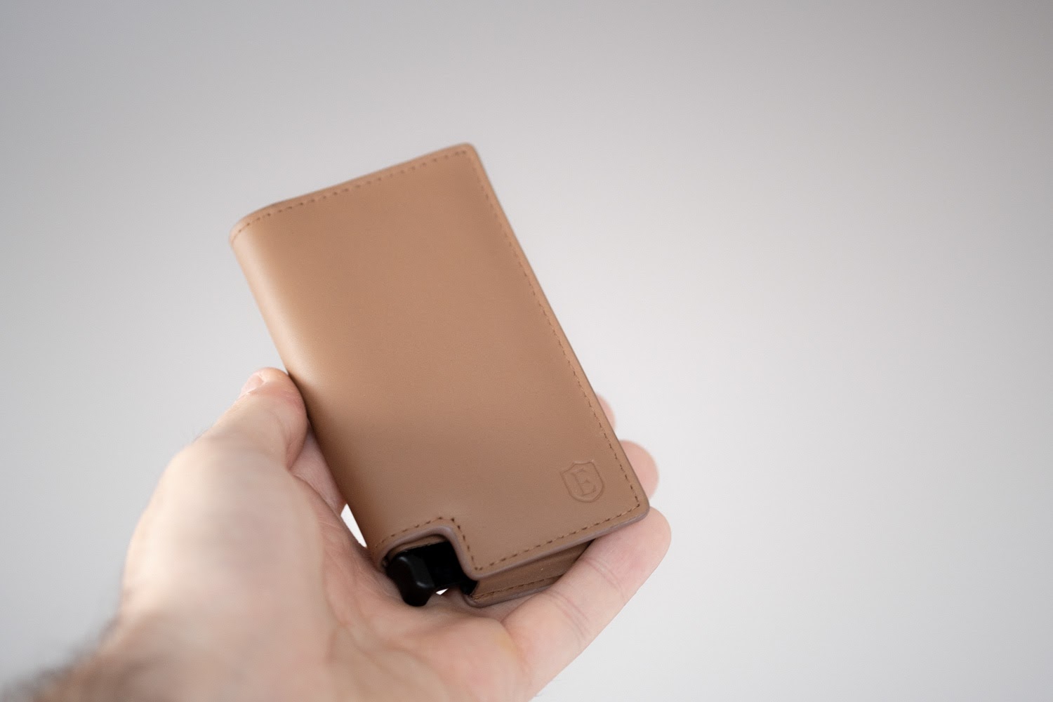 man holding ekster wallet in hand