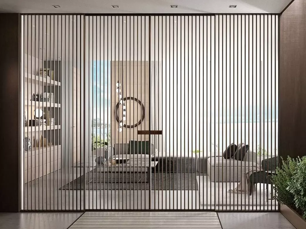 closed slatted sliding door revealing living area with couches