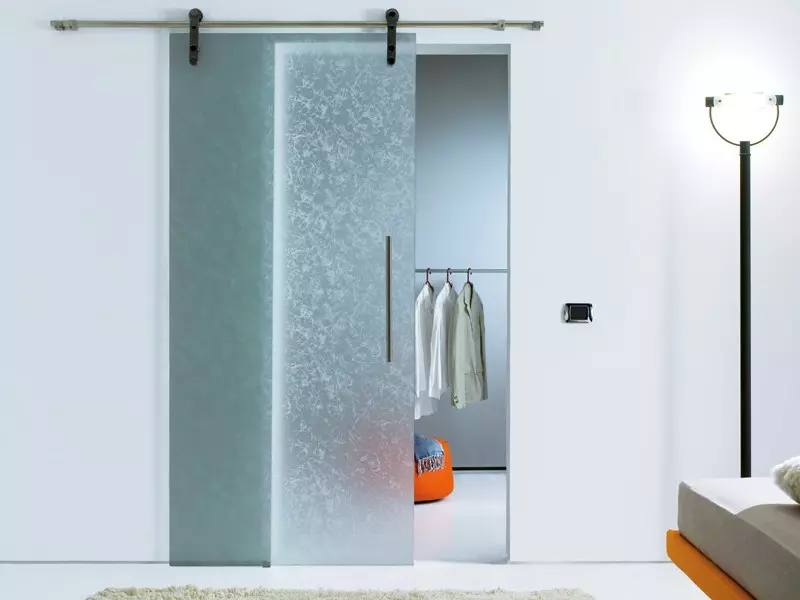 Frosted glass sliding door leading into closet