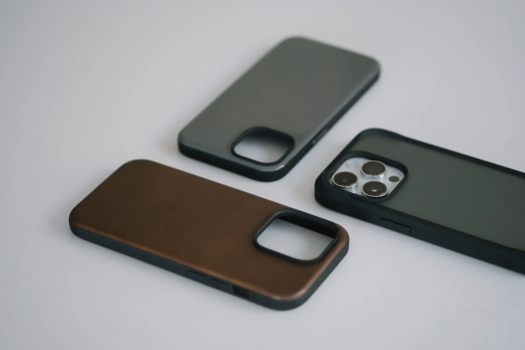 3 iphone cases on an angle on a white table