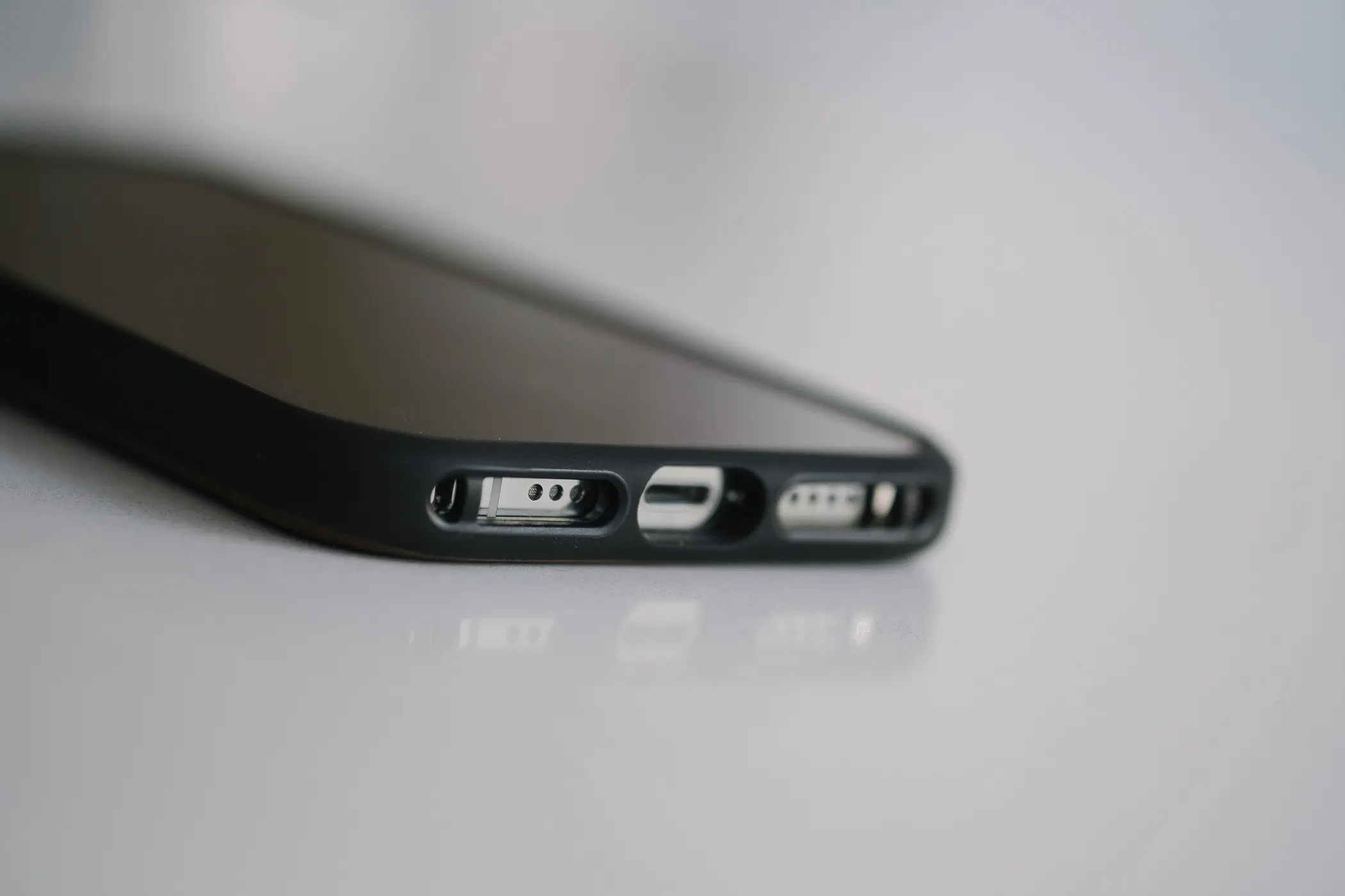 Closeup of bottom of phone showing speaker and charging port