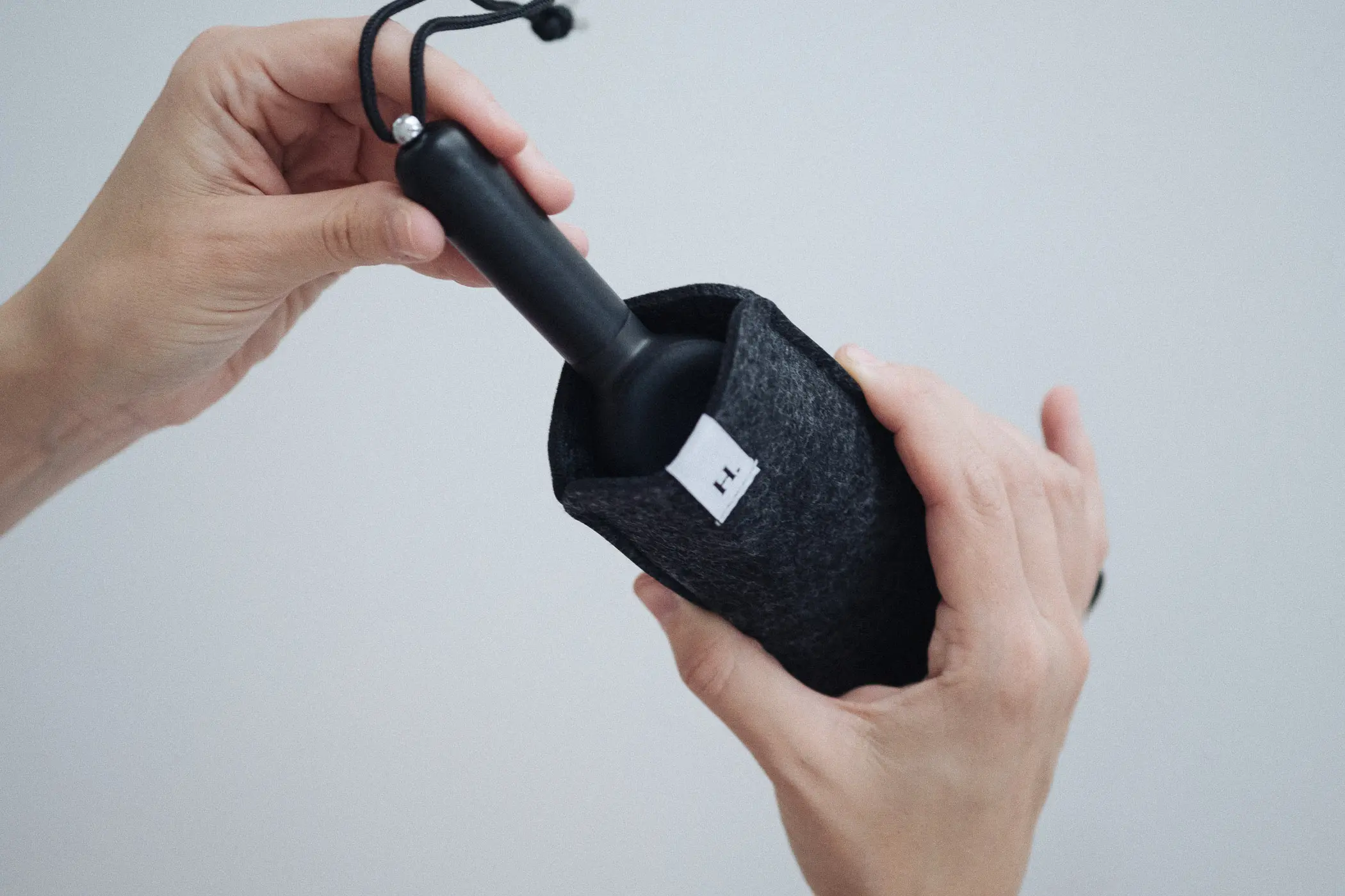 woman putting pipe into felt case