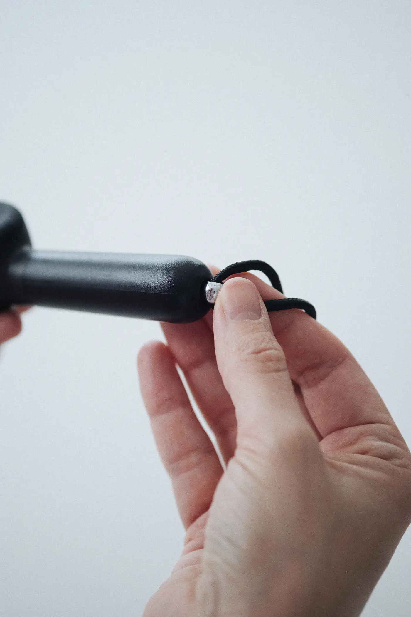 woman putting cleaning tool inside of heir handpipe