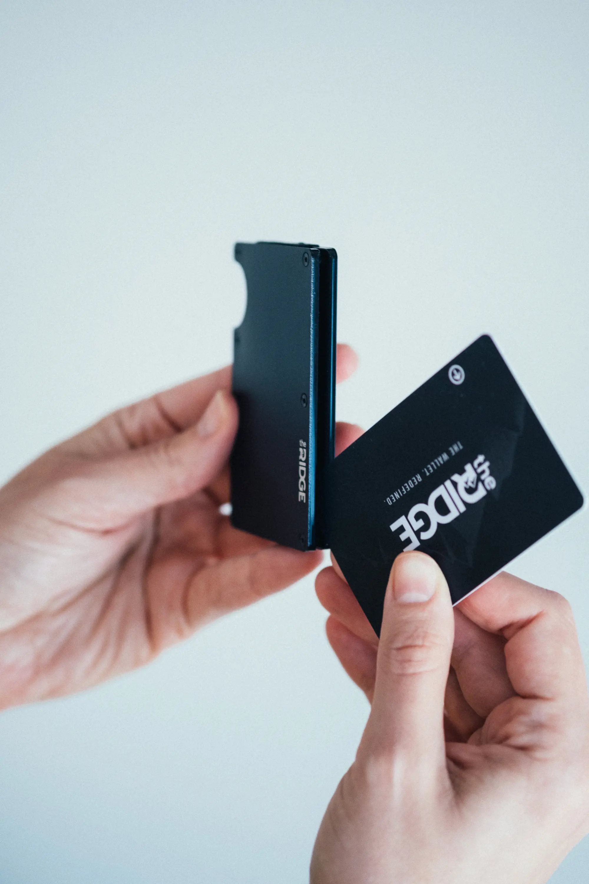 Woman placing card inside of ridge wallet