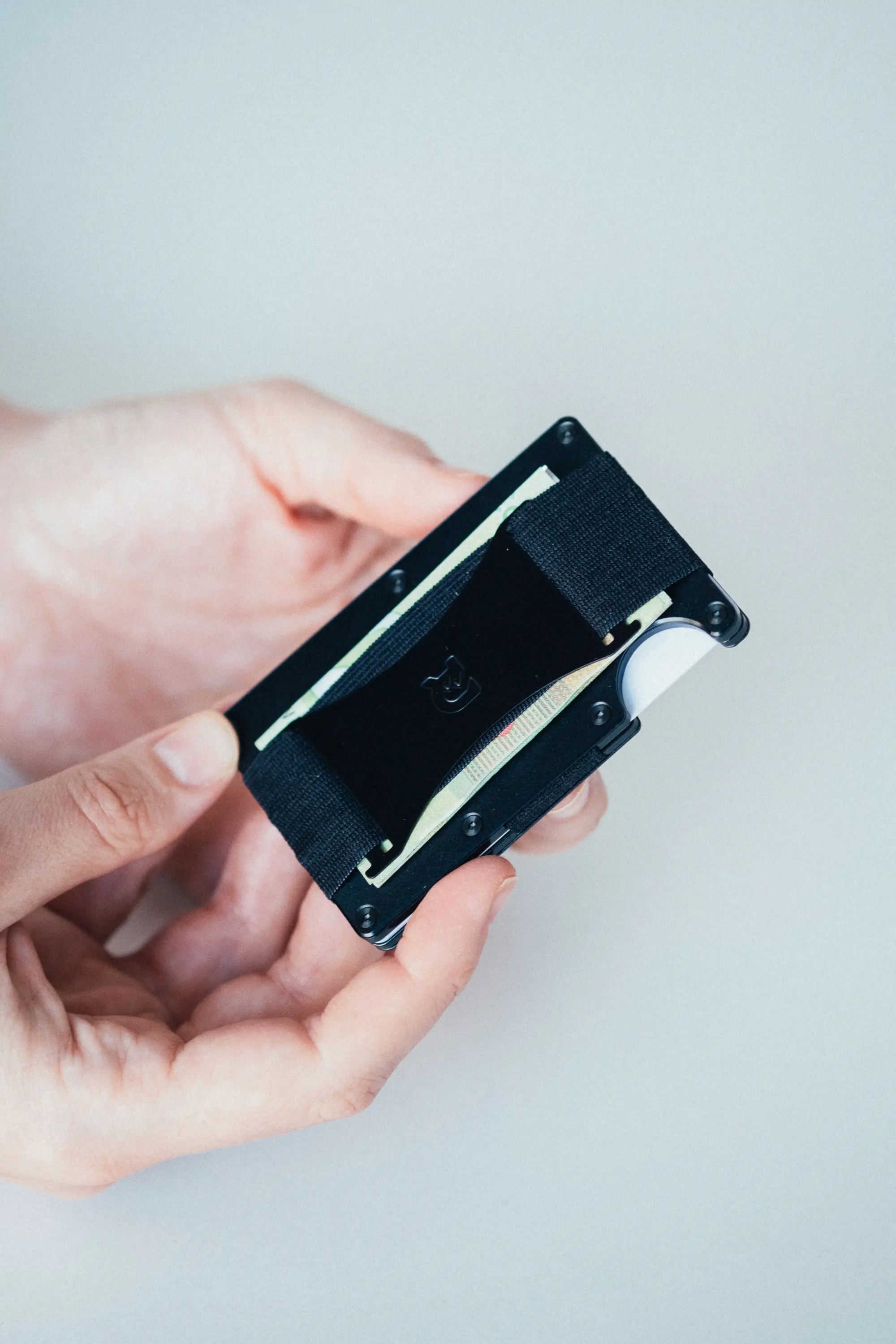 Woman holding up wallet showing bill inside