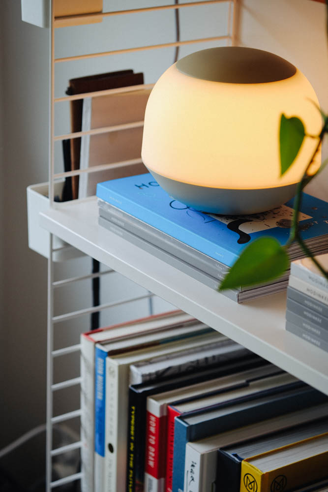 Lamp sitting on some books on a shelf